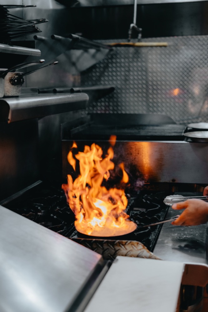 A chef cooking over an open flame